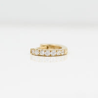 A 10mm single Diamond Huggie in Yellow Gold against a white background