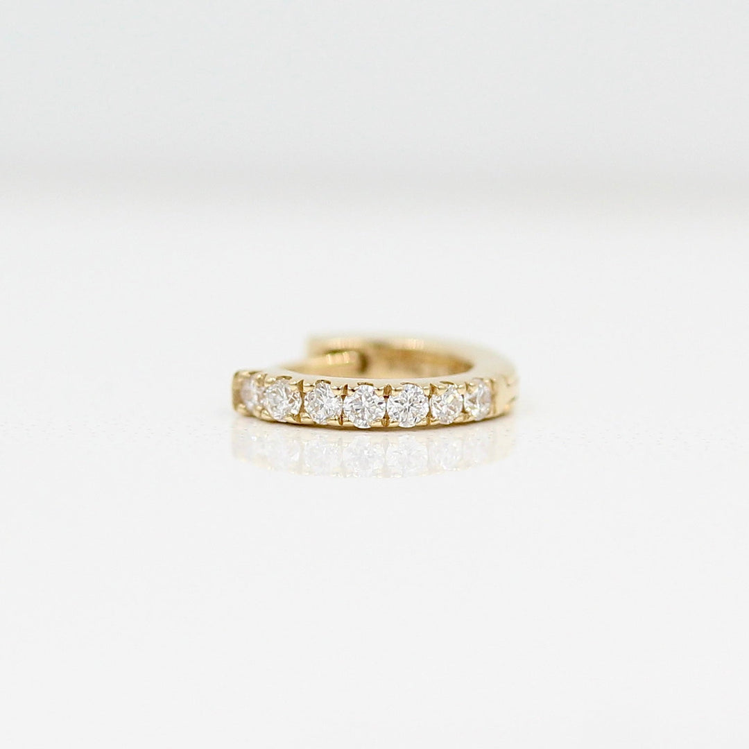 10mm Single Diamond Huggie in Yellow Gold against a white background