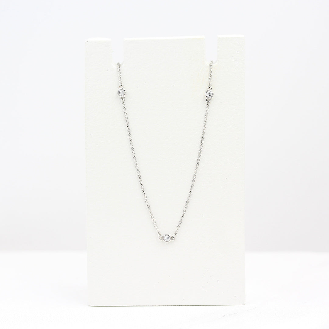 Diamond Station Necklace in White Gold on a white foam piece against a white background