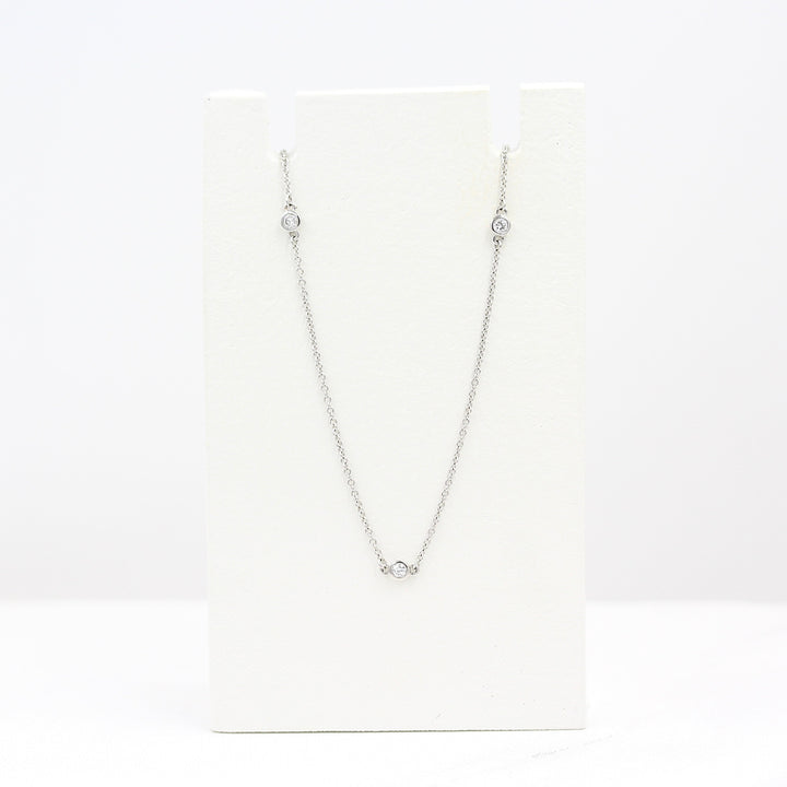 Diamond Station Necklace in White Gold on a white foam piece against a white background