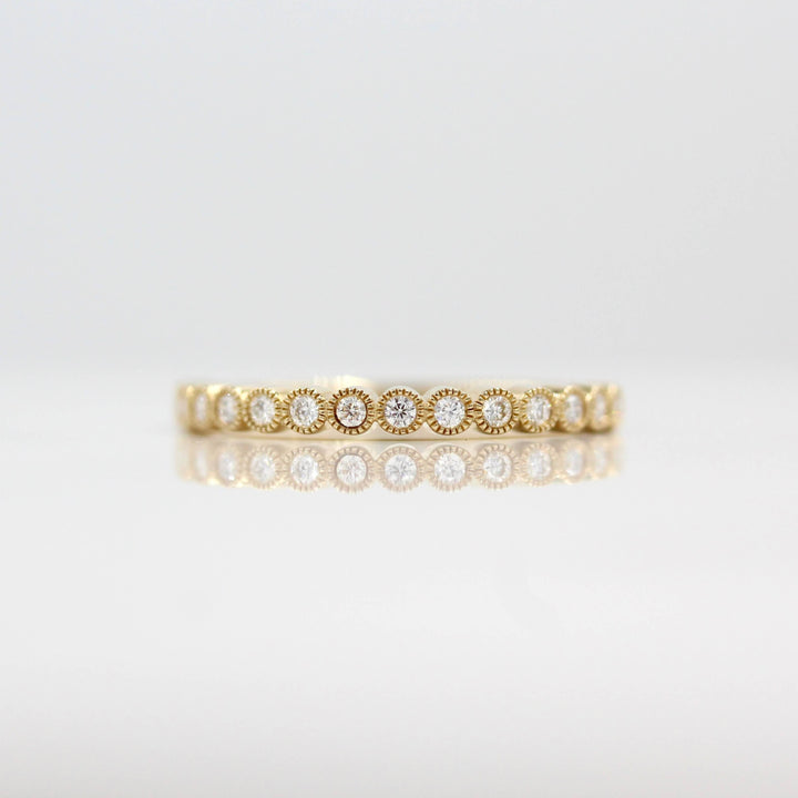 The April Florence Birthstone Wedding Band with Lab-Grown Diamond in Yellow Gold against a white background