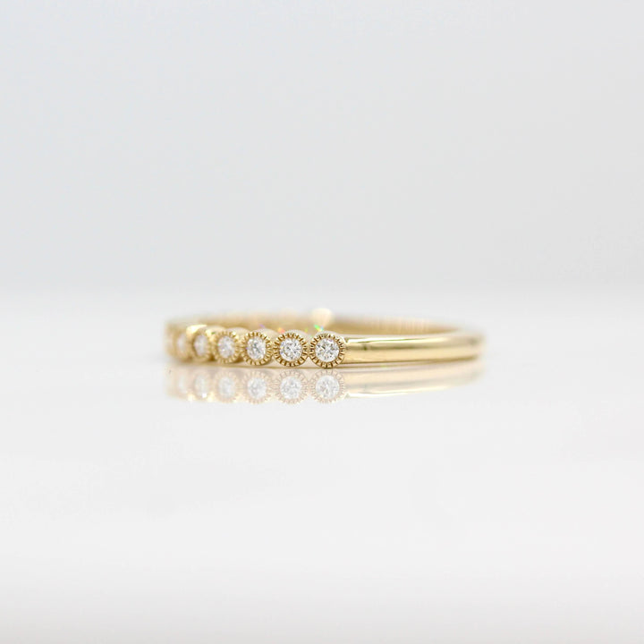 The April Florence Birthstone Wedding Band with Lab-Grown Diamond in Yellow Gold against a white background