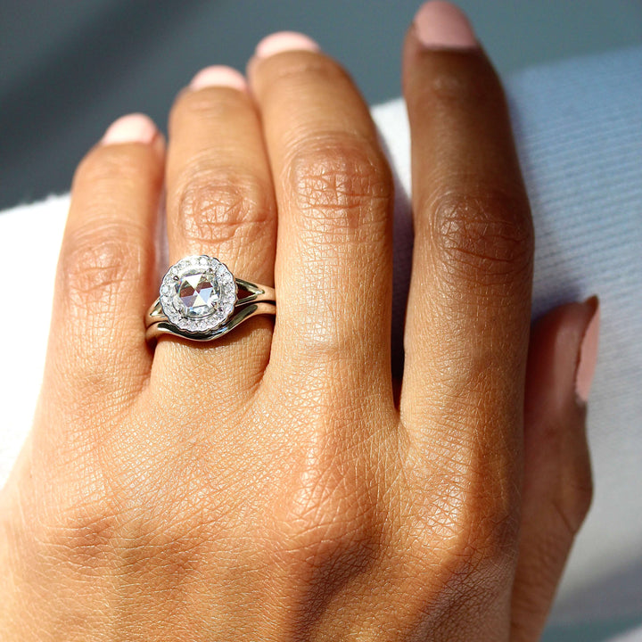 The Diana Ring in White Gold stacked with the Wave wedding band modeled on a hand