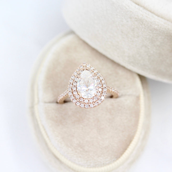 The Double-Halo Carly Ring in Rose Gold in a white velvet ring box