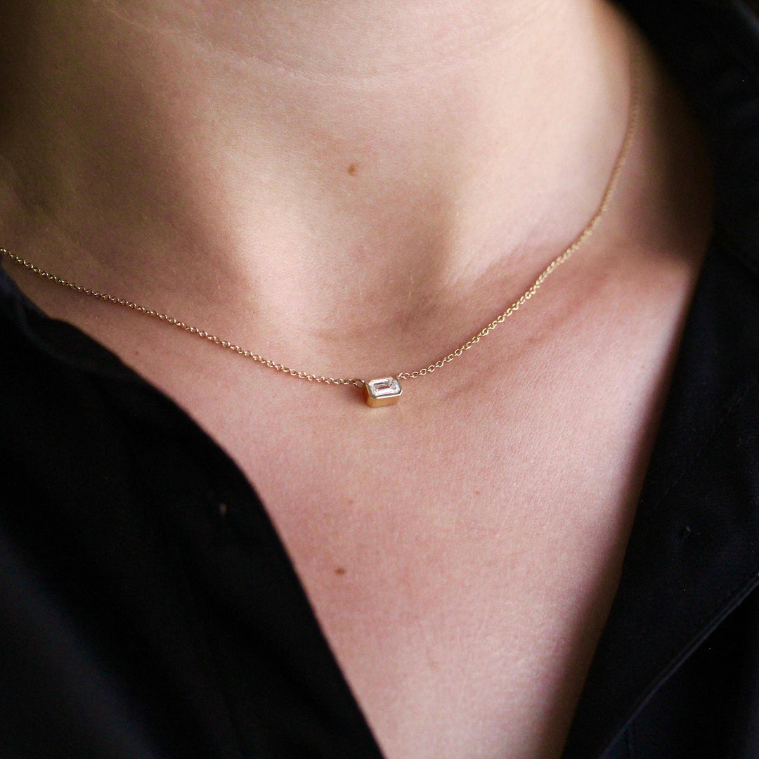 The East-West Emerald Bezel Necklace in Yellow Gold modeled