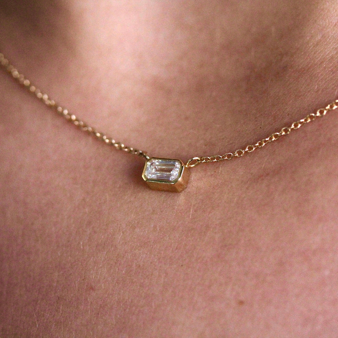 The East-West Emerald Bezel Necklace in Yellow Gold modeled
