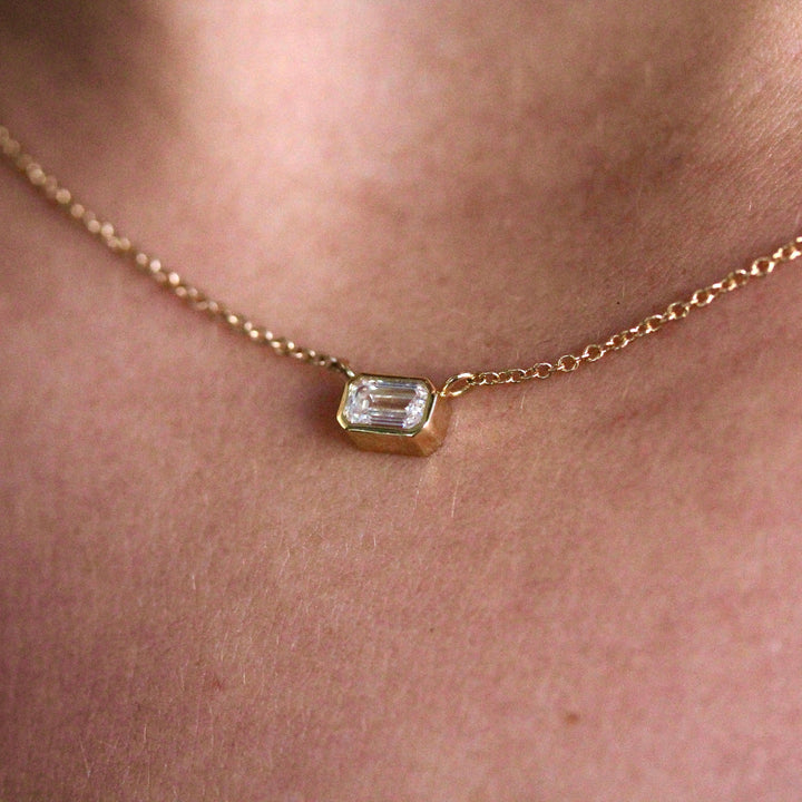 The East-West Emerald Bezel Necklace in Yellow Gold modeled