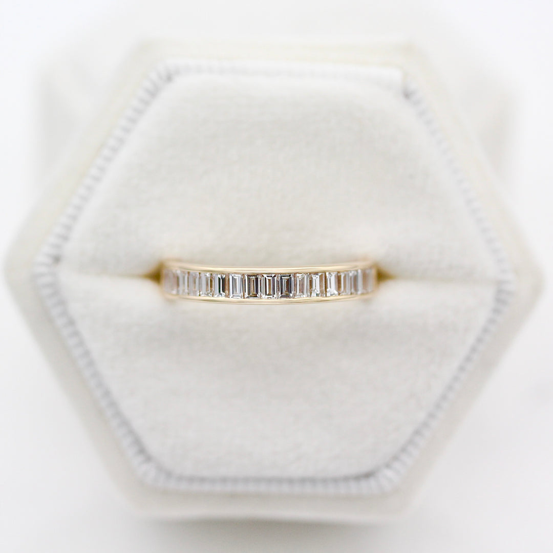 The Elle Wedding Band modeled in a white velvet ring box. 