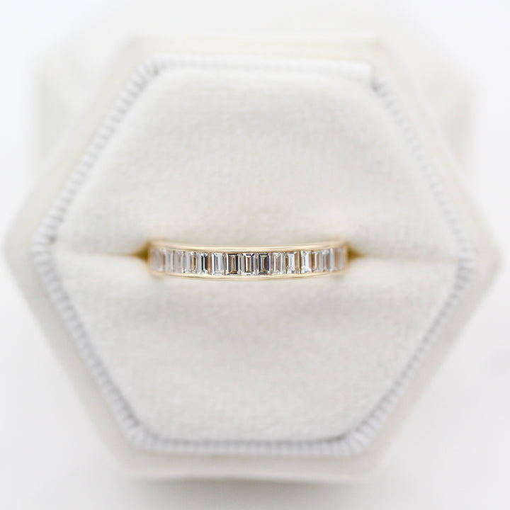 The Elle Wedding Band modeled in a white velvet ring box. 