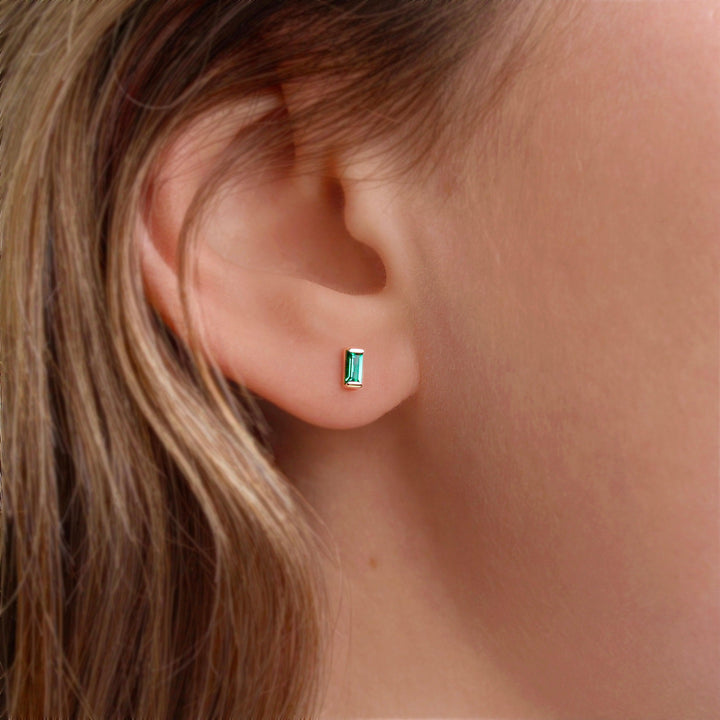 The May Baguette Birthstone Earrings with Emerald in Yellow Gold modeled