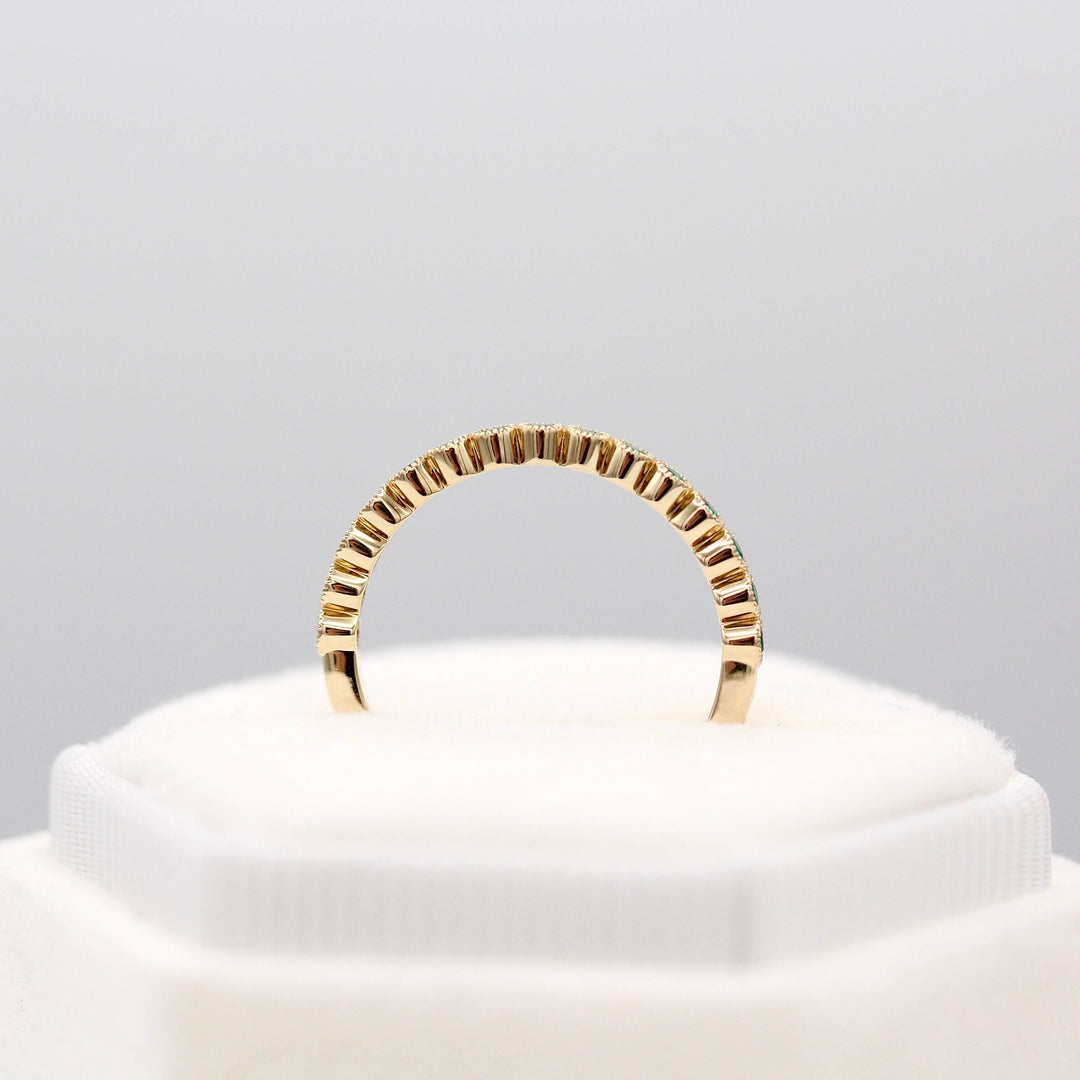 The May Florence Birthstone Wedding Band with Emerald in Yellow Gold in a white velvet ring box