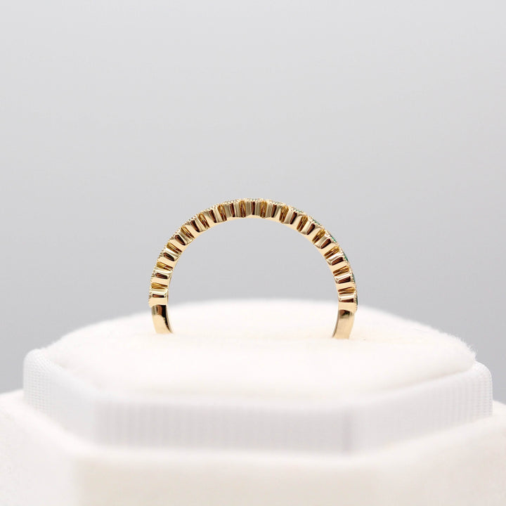 The May Florence Birthstone Wedding Band with Emerald in Yellow Gold in a white velvet ring box