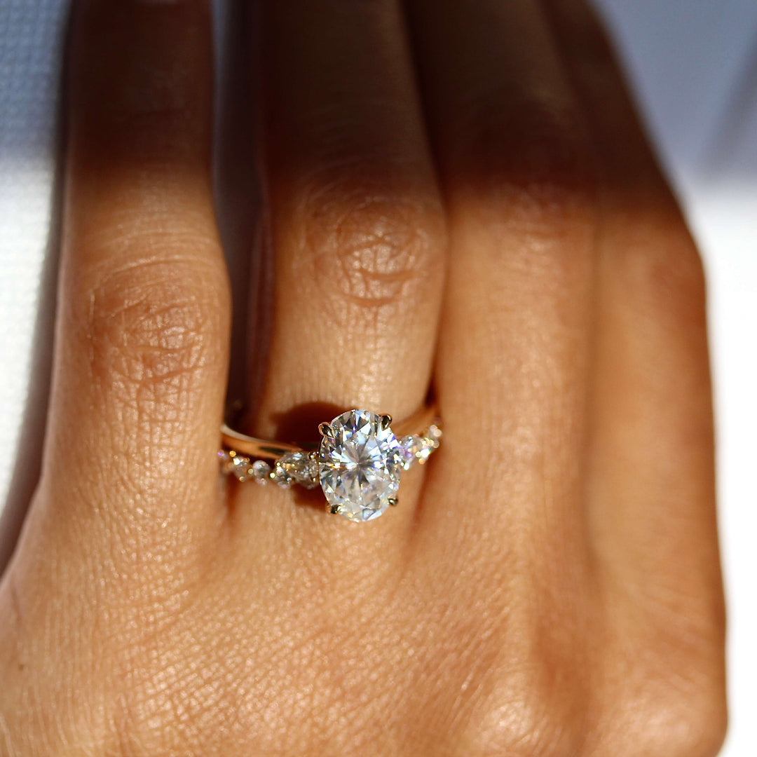 The Emery ring in yellow gold stacked with the carly wedding band in yellow gold modeled on a hand