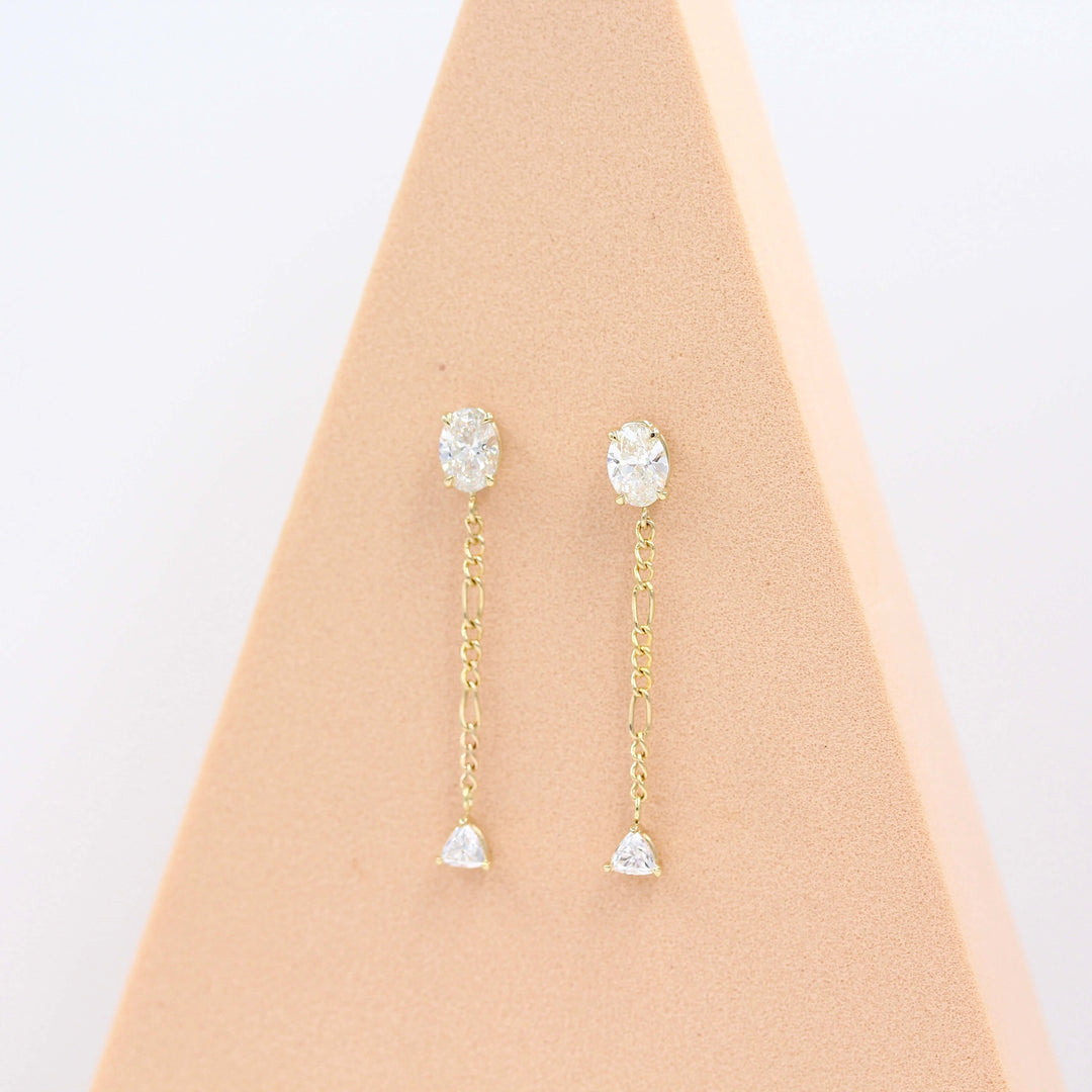 The Emilia Earrings in yellow gold in a pink triangular piece of foam