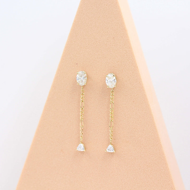The Emilia Earrings in yellow gold in a pink triangular piece of foam