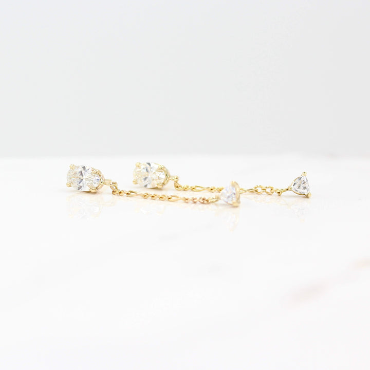 The Emilia Earrings in yellow gold against a white background