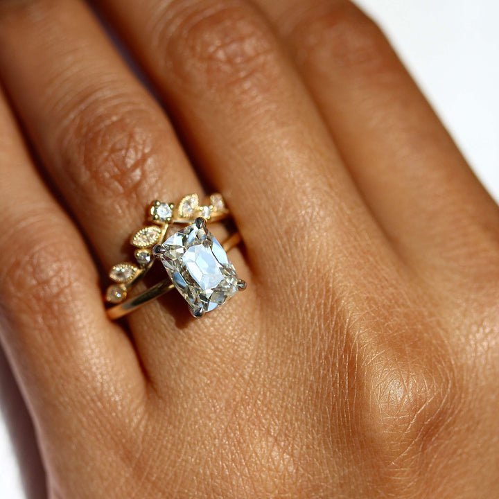 The Eri Ring in Platinum and 18k Yellow Gold with a 3ct Lab Grown Diamond stacked with the Clementine wedding band in yellow gold modeled on a hand