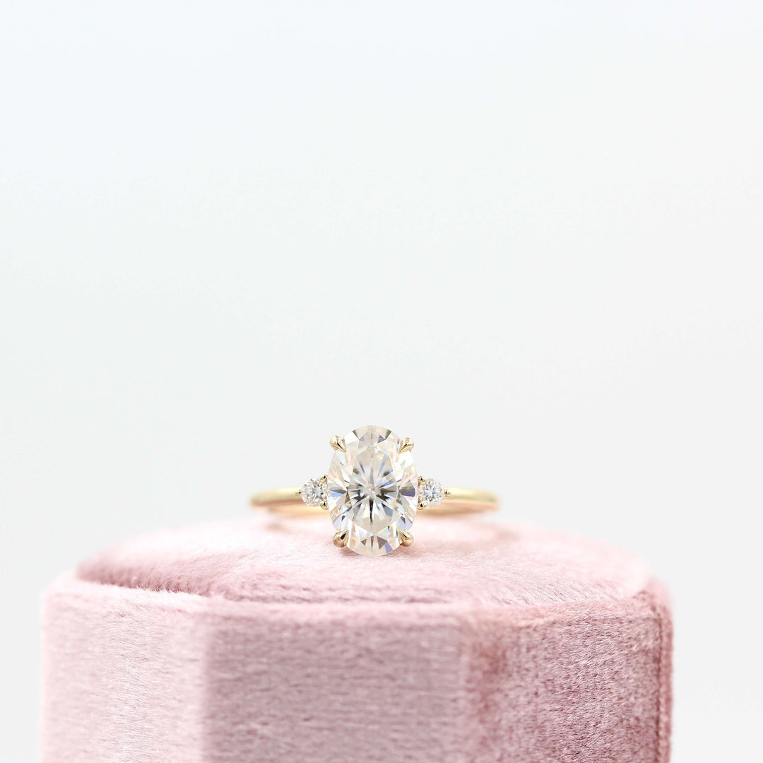 Esme oval ring in yellow gold on a pink velvet ring box