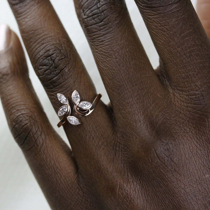 Floral-inspired lab grown diamond engagement ring modeled on a hand