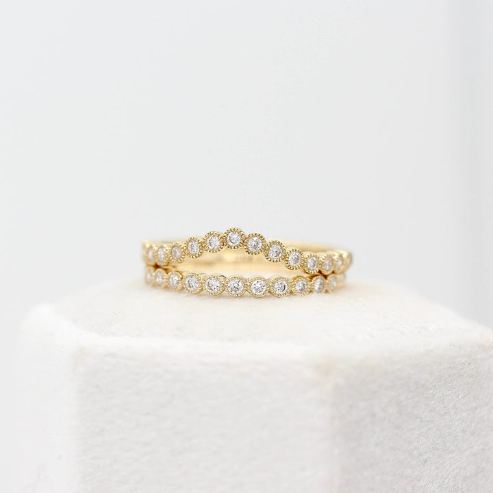 The Florence Wedding Band in Yellow Gold stacked with The Florence Contour Wedding Band in Yellow Gold atop a ring box