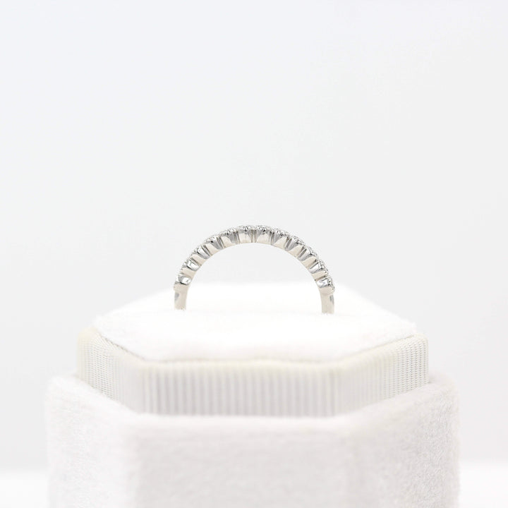 The Florence Wedding Band in white gold in a white velvet ring box's profile view