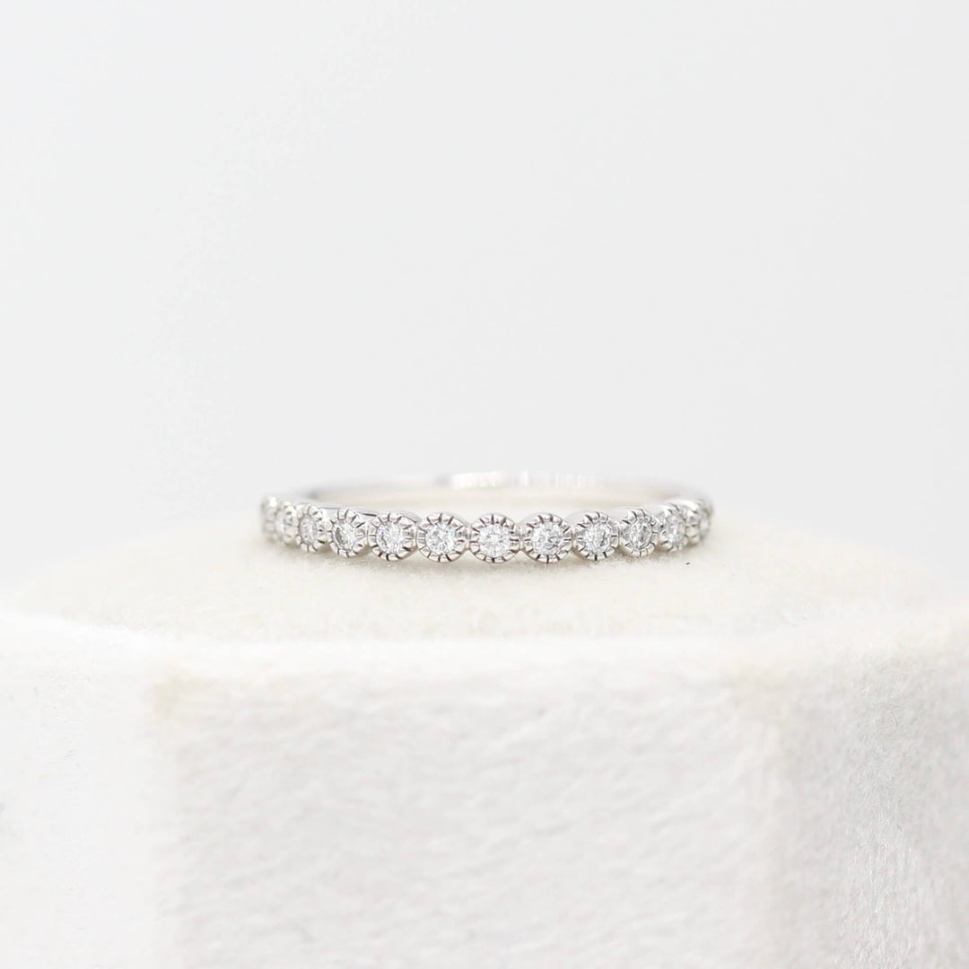 The Florence Wedding Band in white gold atop of a white velvet ring box