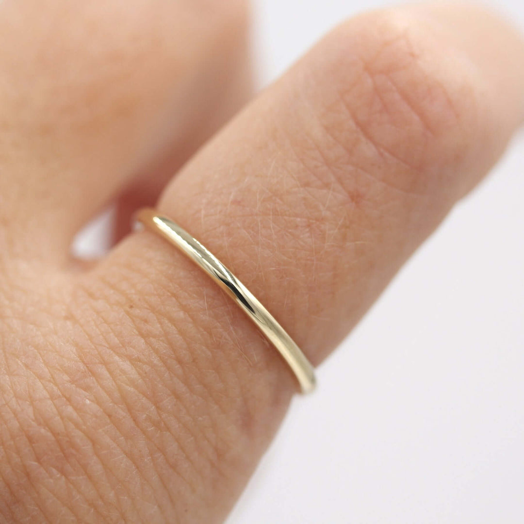 Gold stacking band worn alone on an index finger