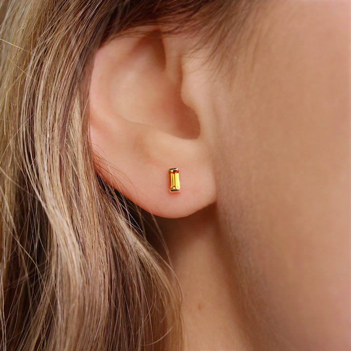 The November Baguette Birthstone Earrings with Gold Sapphire in Yellow Gold modeled