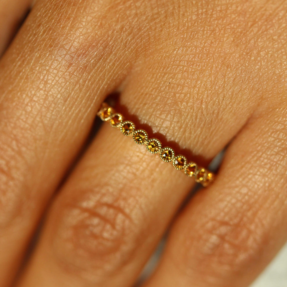 The November Florence Birthstone Wedding Band with Gold Sapphire in Yellow Gold modeled