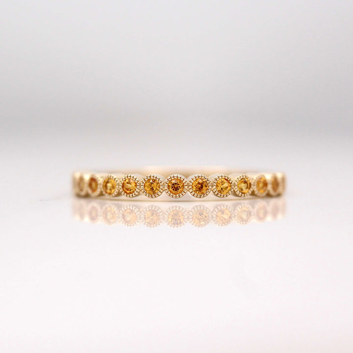 The November Florence Birthstone Wedding Band with Gold Sapphire in Yellow Gold against a white background