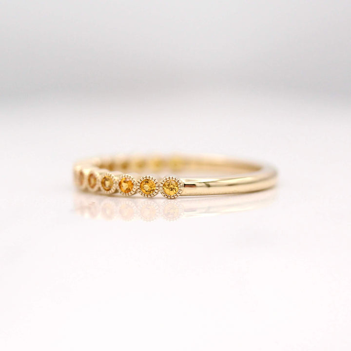 The November Florence Birthstone Wedding Band with Gold Sapphire in Yellow Gold against a white background