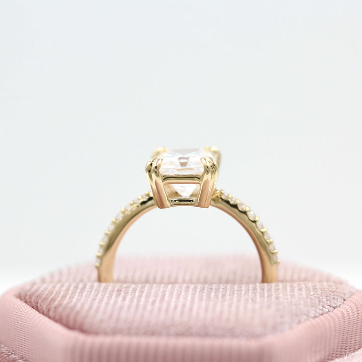 Profile of radiant moissanite engagement ring in a velvet box