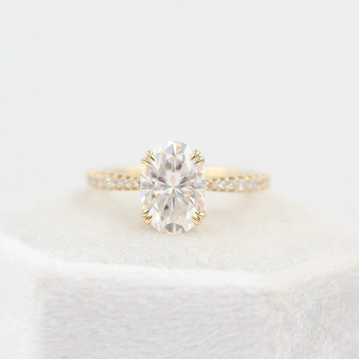 The Grace Ring (Oval) in Yellow Gold and 2ct Moissanite atop a white velvet ring box