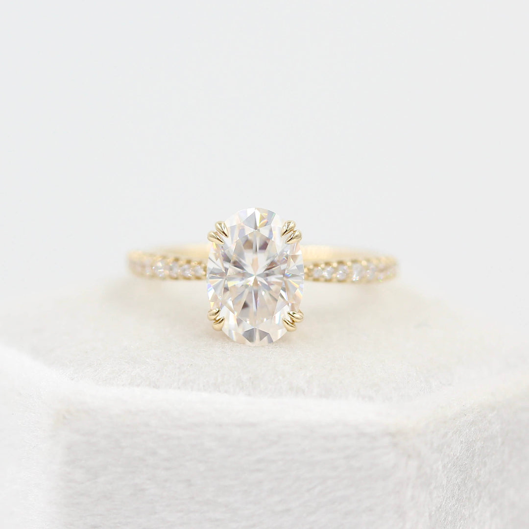 The Grace Ring (Oval) in Yellow Gold and 2ct Moissanite atop a white velvet ring box