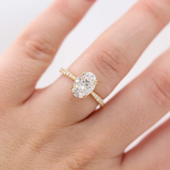 The Grace Ring (Oval) in Yellow Gold and 2ct Moissanite modeled on a hand