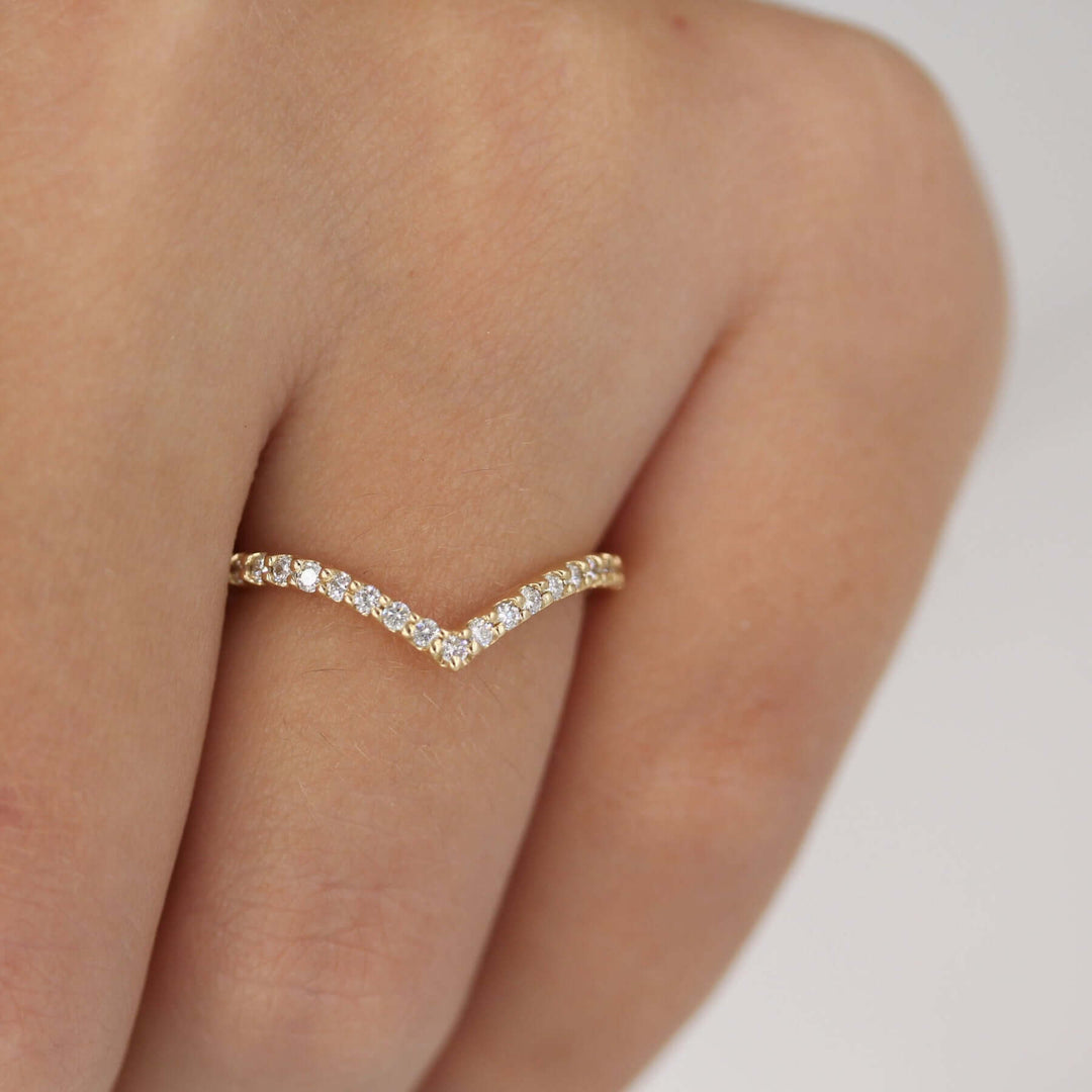 Hand wearing 14k yellow gold lab-grown diamond v band