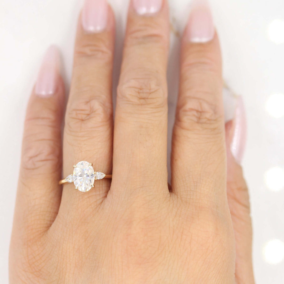 Hand wearing 2ct oval moissanite engagement ring