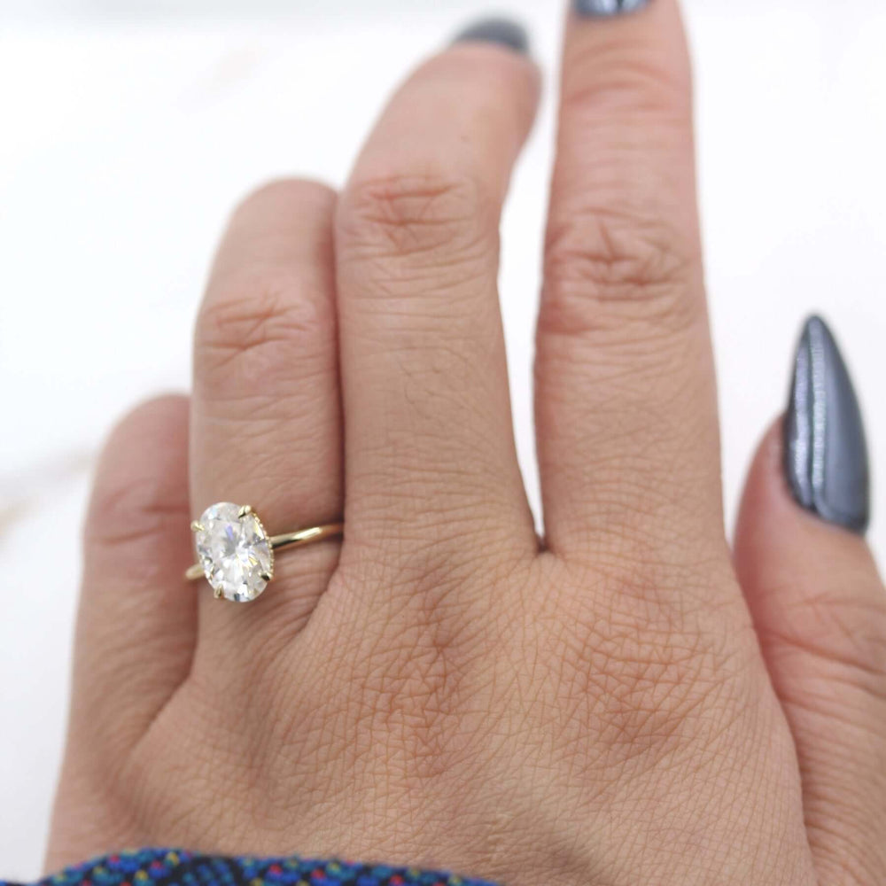 Hand wearing 2ct oval moissanite engagement ring