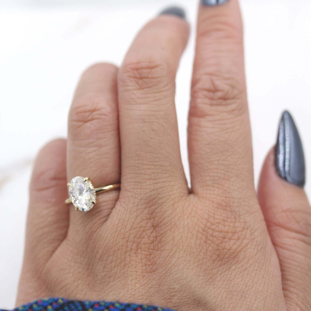 Hand wearing 2ct oval moissanite engagement ring