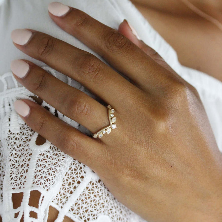 Hand wearing diamond v-band with marquise and round lab-grown diamonds