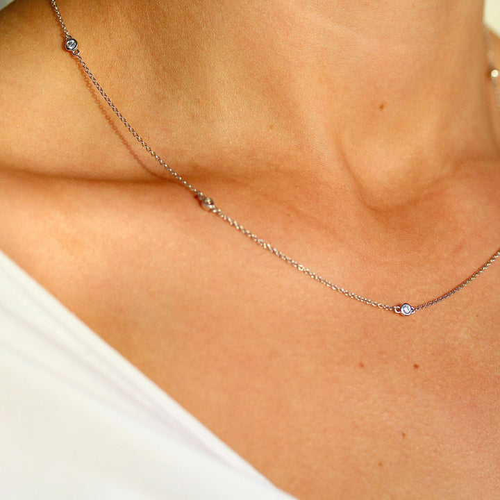 The Diamond Station Necklace in white gold modeled on a neck