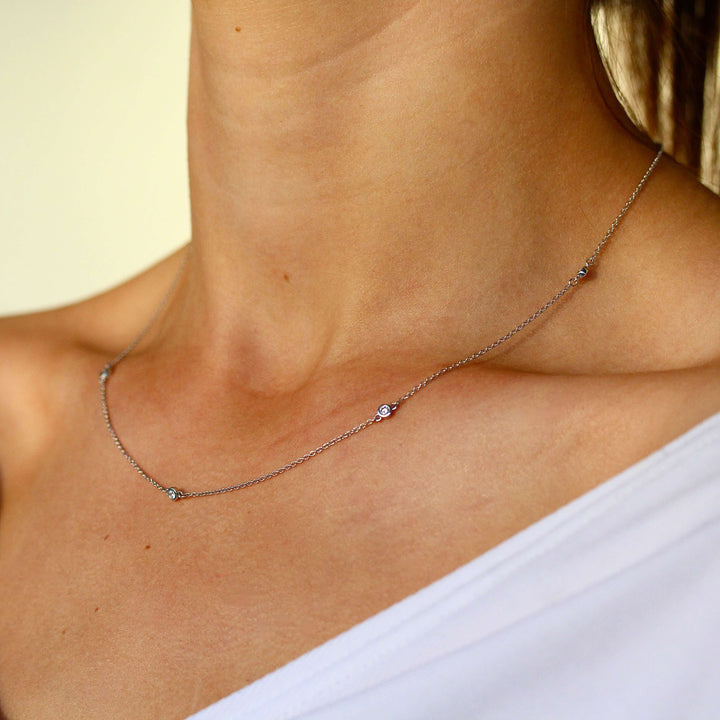 The Diamond Station Necklace in white gold modeled on a neck