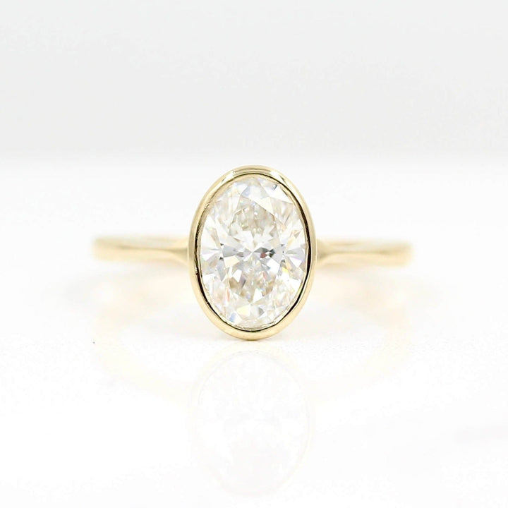 The Stevie Ring (Oval) in Yellow Gold with Lab Grown Diamond against a white background