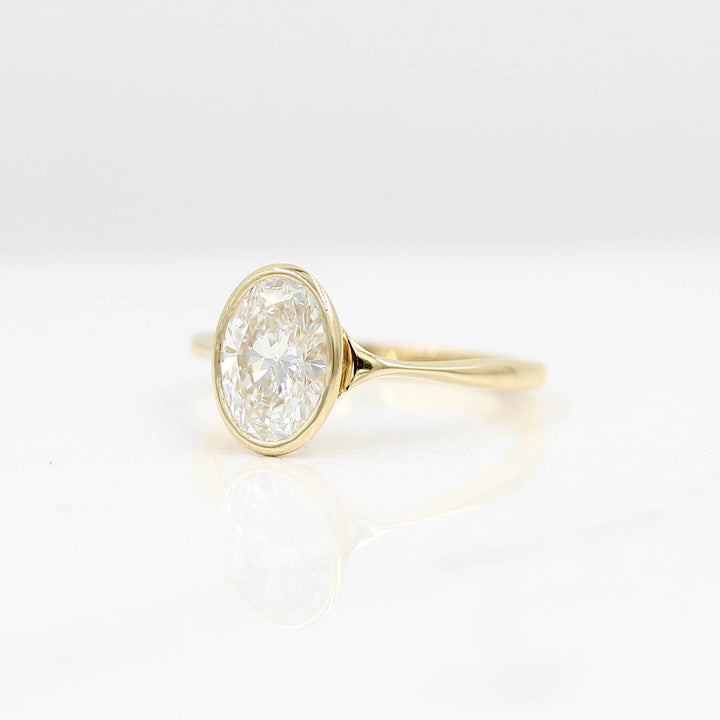 The Stevie Ring (Oval) in Yellow Gold with Lab Grown Diamond against a white background