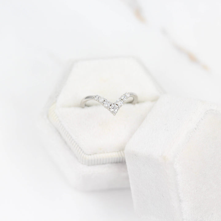 The Graduated Diamond V-Band in white gold in a white velvet ring box