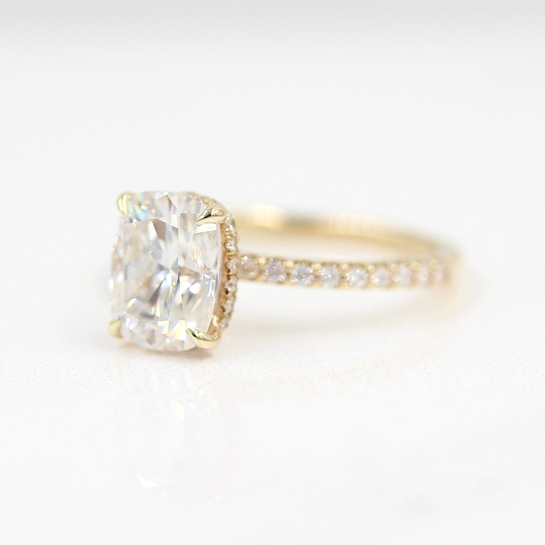 The Paris Hidden Halo Ring (Cushion) in yellow gold against a white background