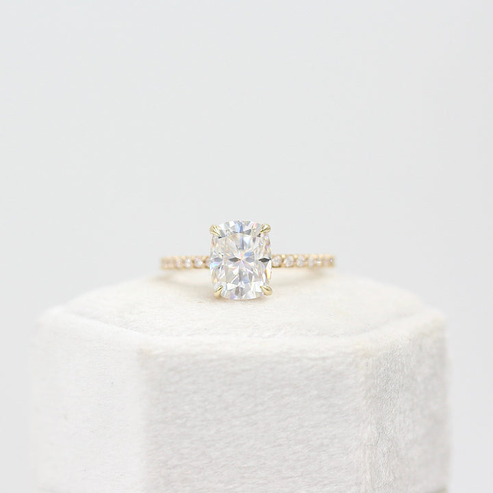 The Paris Hidden Halo Ring in Yellow Gold with 2ct Moissanite atop of a white background