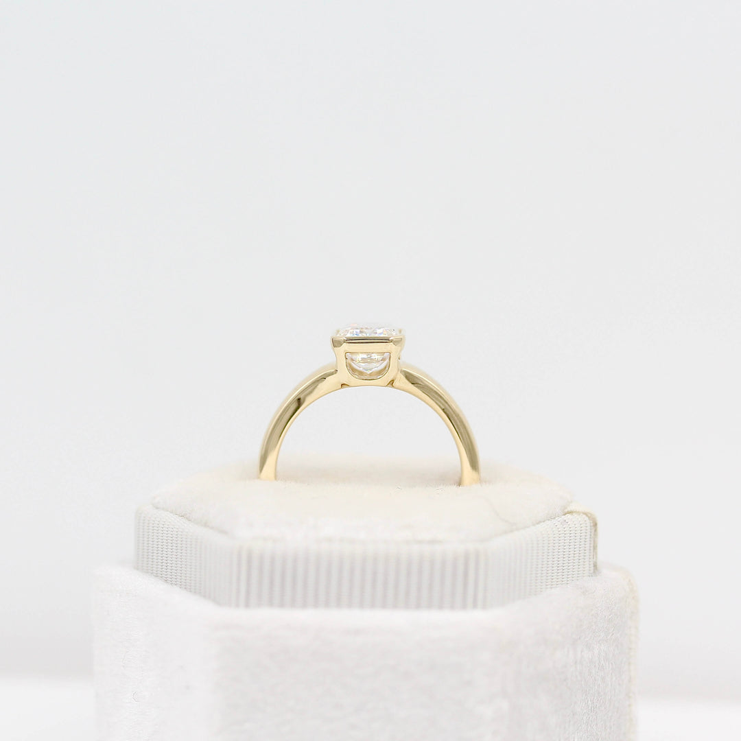 The Billie Ring in yellow gold in a white velvet ring box