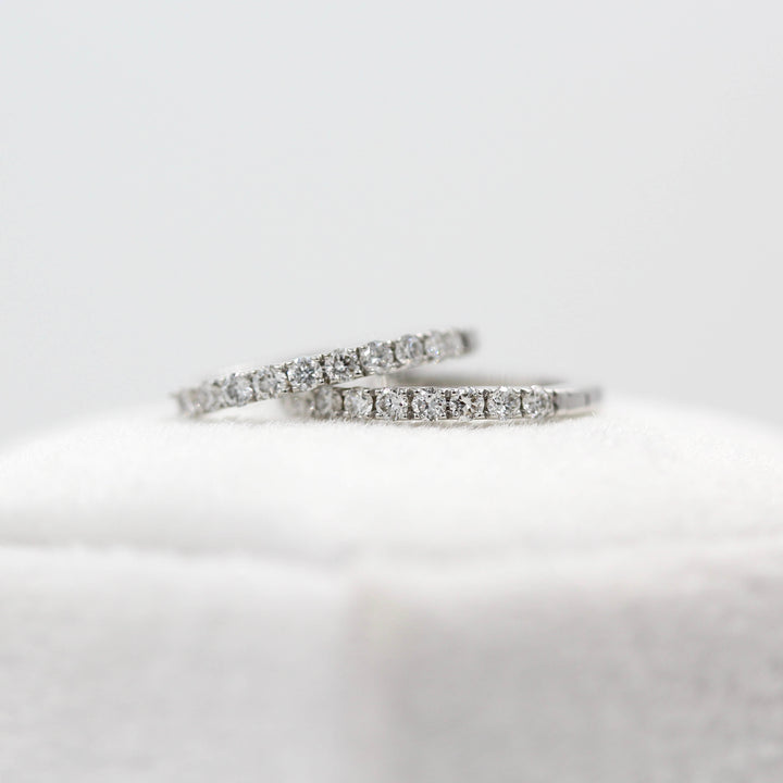 The 14mm Diamond Huggies in White Gold atop a white velvet ring box