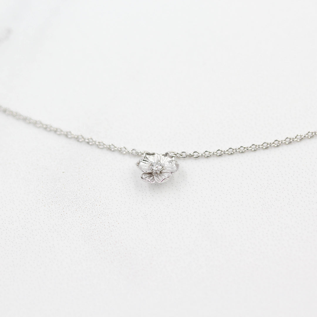 The Poppy Necklace in White Gold against a white background